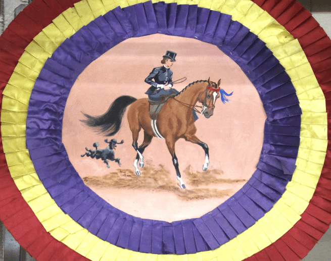 Horse Show prize ribbon with painting of rider on it